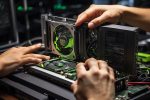 An enthusiastic person who loves computer games and holds an nvidia quadro k2000 graphics card in his hand