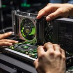 An enthusiastic person who loves computer games and holds an nvidia quadro k2000 graphics card in his hand
