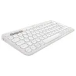 Clavier sans fil Logitech Pebble Keys 2 K380s blanc, avec une disposition AZERTY, dans un environnement de bureau moderne avec un ordinateur portable et un smartphone.